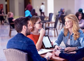students group working on school  project  together on tablet computer  at modern university
